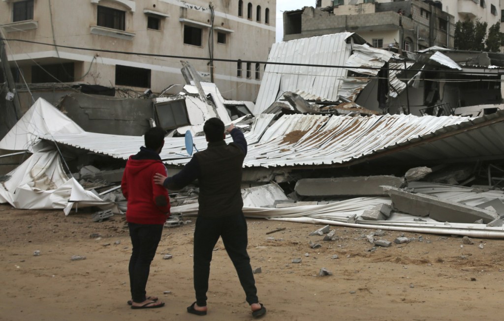 Palestinians inspect the damage to the Hamas ministry of prisoners, which was hit by Israeli airstrikes early Friday in Gaza City. Israeli warplanes attacked militant targets in the southern Gaza Strip in response to a rare rocket attack on the Israeli city of Tel Aviv, as the sides appeared to be hurtling toward a new round of violence.