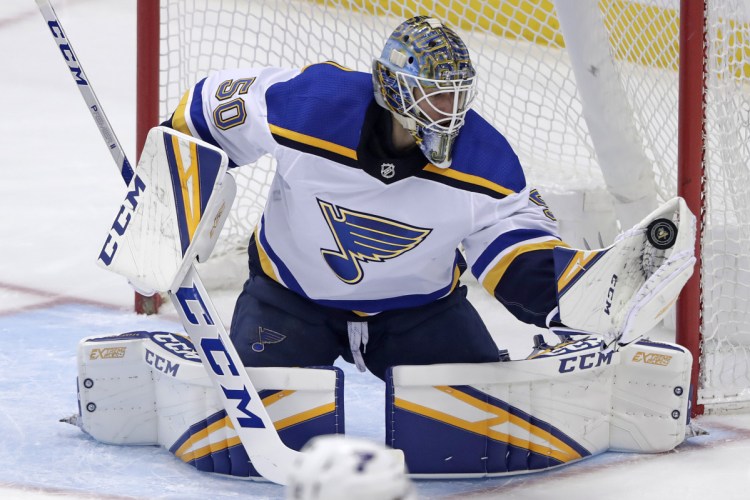 St. Louis Blues goaltender Jordan Binnington gloves a shot during the first period of Saturday's game in Pittsburgh.