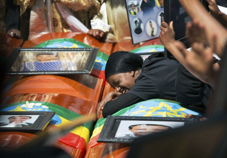 A grief-stricken woman breaks down at a mass funeral for victims of Flight 302 at the Holy Trinity Cathedral in Addis Ababa, Ethiopia, on Sunday.
