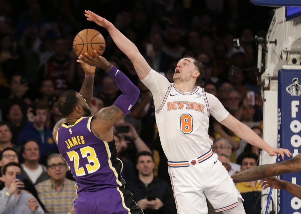 Mario Hezonja of the New York Knicks blocks a potential winning shot by LeBron James of the Los Angeles Lakers with two seconds remaining, preserving New York's 124-123 victory at home Sunday.