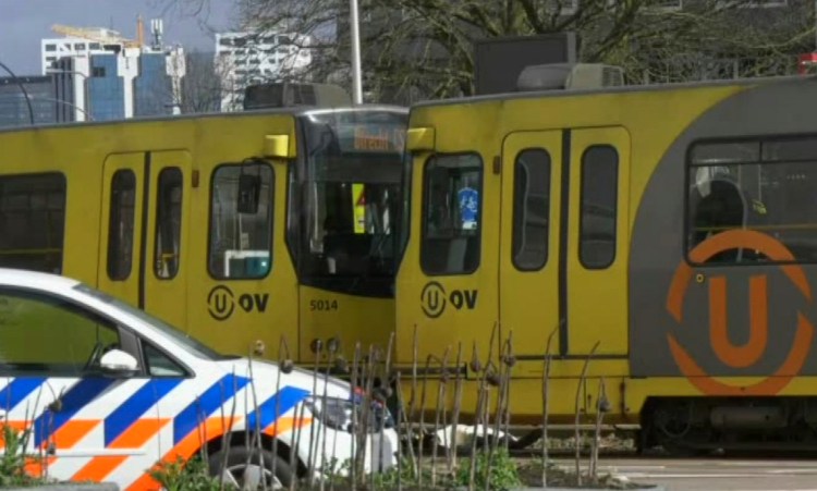 In this image taken from video, a body lies next to a tram as emergency responders attend the scene of a shooting Monday in Utrecht, Netherlands, that killed three people and injured five.