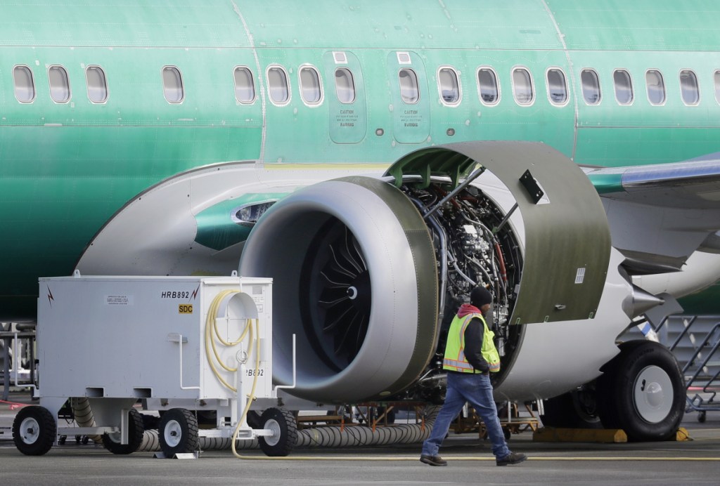 A worker walks past an engine on a Boeing 737 MAX 8 airplane being built for American Airlines at Boeing Co.'s assembly plant in Renton, Wash., last week.