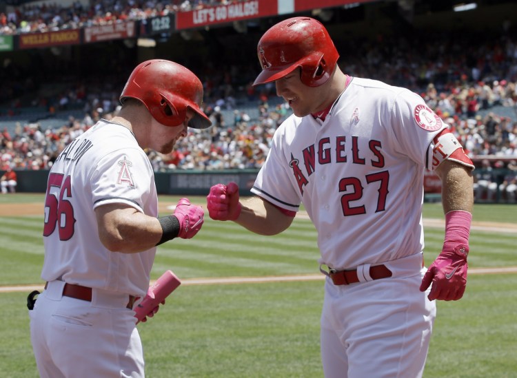 Los Angeles' Mike Trout, right, shown celebrating with Kole Calhoun after hitting a home run in May 2017, is working on a $430 million contract extension with the Angels. (AP Photo/Alex Gallardo)