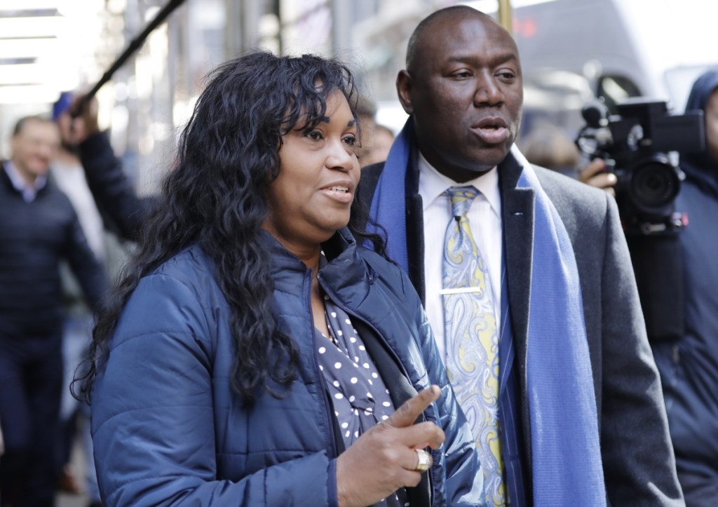 Tamara Lanier and attorney Benjamin Crump arrive for a news conference near the Harvard Club on Wednesday in New York. Lanier is suing Harvard University for "wrongful seizure, possession and expropriation" of images she says depict two of her ancestors.