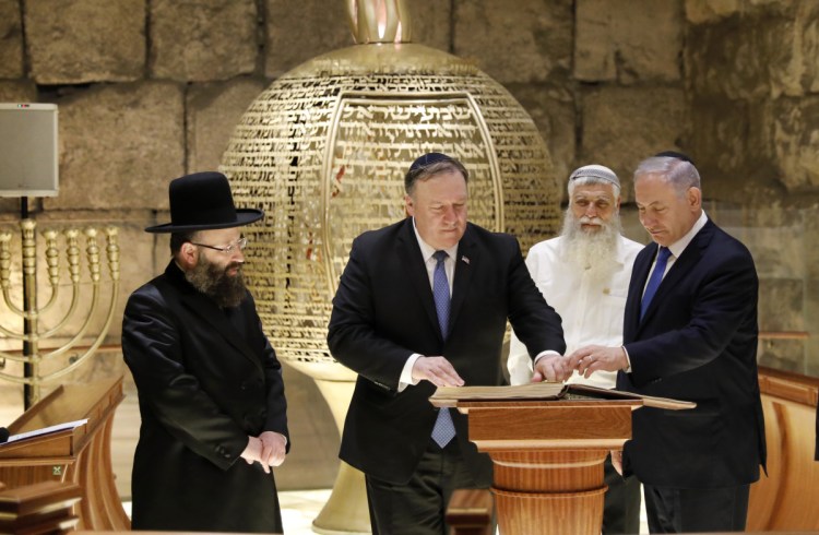From left, Rabbi of the Western Wall Shmuel Rabinovitch, U.S Secretary of State Mike Pompeo, center, and Israeli Prime Minister Benjamin Netanyahu visit the Western Wall tunnels synagogue in Jerusalem's Old City on Thursday.