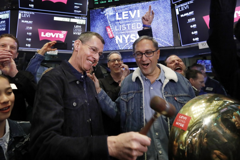 Levi Strauss CEO Chip Bergh, left, is joined by CFO Harmit Singh as he rings a ceremonial bell during his company's IPO Thursday on the floor of the New York Stock Exchange.