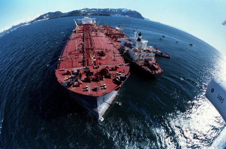 The grounded Exxon Valdez, left, unloads oil onto a smaller tanker in an effort to refloat the Valdez on April 4, 1989. The initial spill, on March 24, 1989,   let about 11 million gallons of crude oil gush into Prince William Sound.