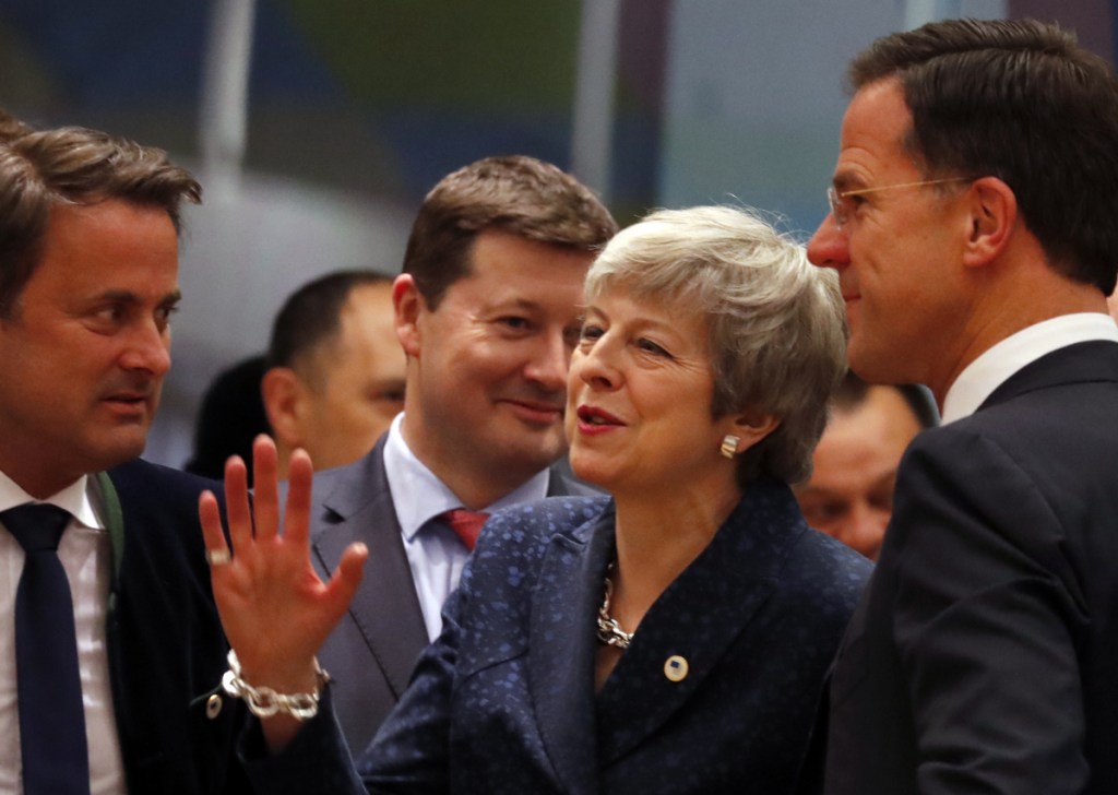 British Prime Minister Theresa May, center, speaks with Dutch Prime Minister Mark Rutte, right, and Luxembourg's Prime Minister Xavier Bettel on Thursday at an EU summit in Brussels. May persuaded European Union leaders to delay Brexit until May, just eight days before Britain was scheduled to leave the bloc.