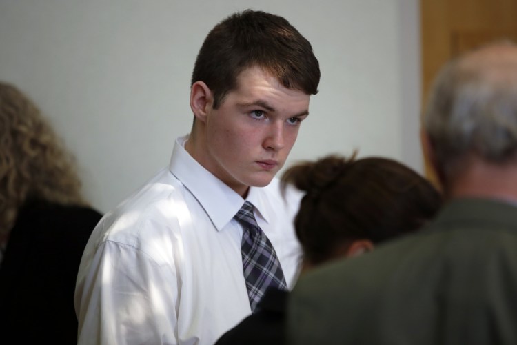 Dominic Sylvester, now 18, confers with lawyers during a recess in his hearing Thursday in West Bath District Court. A judge will decide whether the Bowdoinham teenager will be tried as an adult in the death of his grandmother.