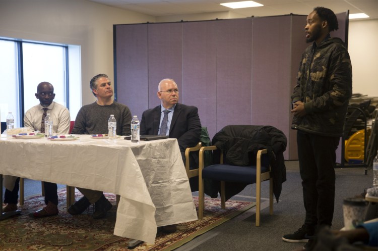 From left, City Councilor Pious Ali, Mayor Ethan Strimling and interim Police Chief Vern Malloch listen to Liban Muse, 23, speak Friday about the death of his younger brother, Isahak Muse, in a shooting on March 16.