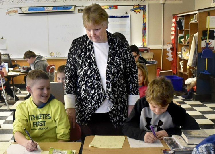 Quimby Middle School teacher Cathy Foran works with fourth-graders in Bingham. This month, residents in SAD 13 towns voted to close the school.