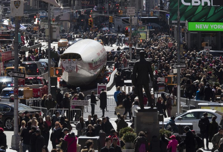 A Lockheed Constellation L-1649A Starliner, known as the Connie, is parked in New York's Times Square during a promotional event, Saturday. The vintage commercial airplane will serve as the cocktail lounge outside the TWA Hotel at JFK airport.
