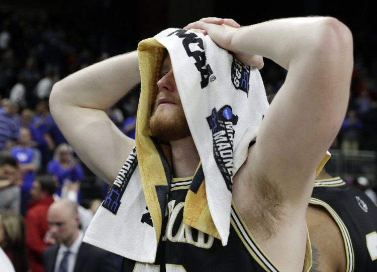 Matthew Pegram of Wofford walks off the court Saturday after his team's season ended with a 62-56 loss to Kentucky in the second round game of the NCAA tournament. Fletcher Magee, the top shooter for Wofford, went 0 of 12 from 3-point range.