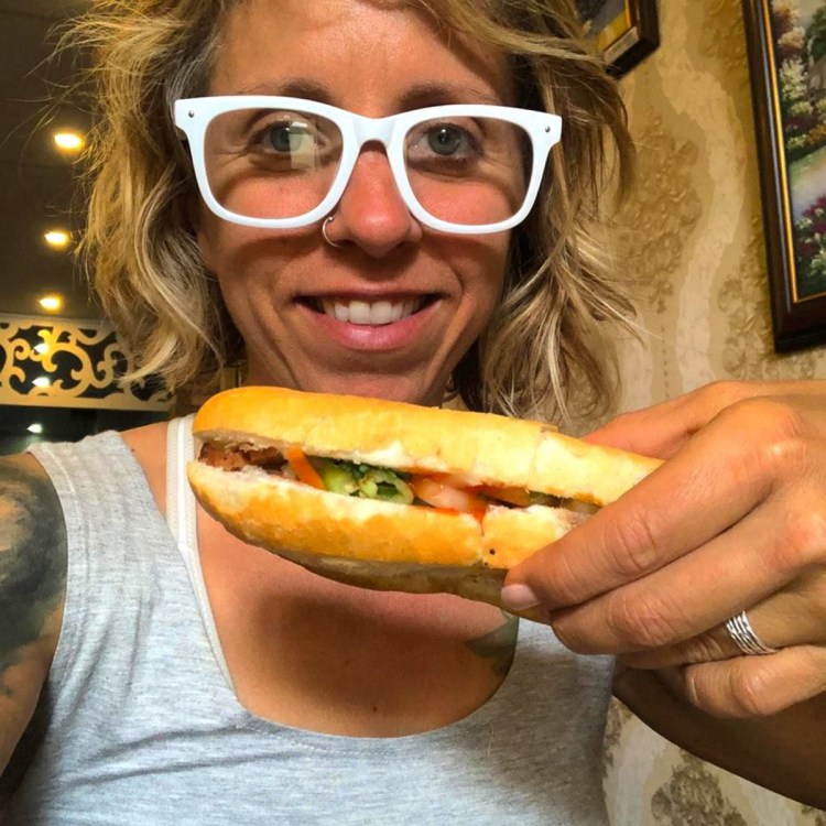 Donna Hickey of Portland enjoys a vegan banh mi while visiting Dalat, Vietnam.