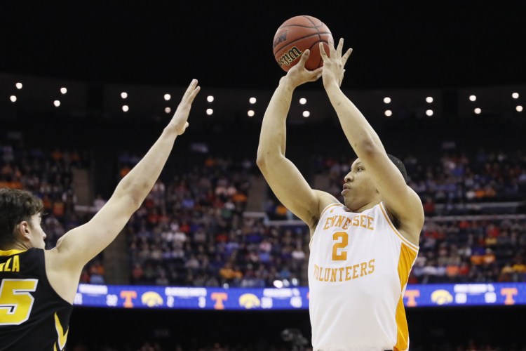 Tennessee's Grant Williams shoots over Luka Garza of Iowa during their second-round NCAA tournament game Sunday in Columbus, Ohio. Tennessee won in overtime, 83-77.