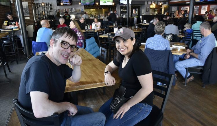 Silver Street Tavern employees Zack Denis and Samantha Clark take a break from serving customers Sunday to talk about the unprecedented $2,000 tip they and other employees will split from an anonymous customer at the Waterville restaurant Saturday.