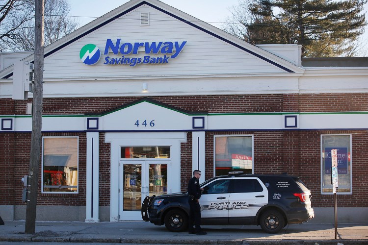 A Portland police crusier sits in front of the Norway Savings Bank branch on Forest Avenue after an armed robbery there on Monday afternoon.