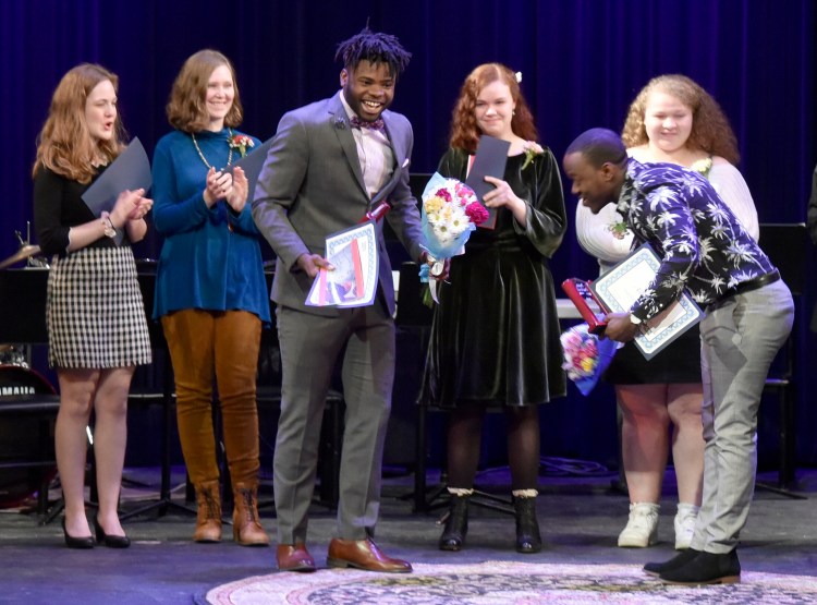 Poetry Out Loud runner-up Allan Monga, right, of Deering High School in Portland, bows to winner Joao Victor of Lewiston High School after the state final held at the Waterville Opera House on Monday. Other participants, from left, are Emily Campbell of Waterville Senior High School, Hanna Lavenson of Messalonskee High School, Magnolia Vandiver of George Stevens Academy in Blue Hill and Aaliyah Biamby of Gorham High School.