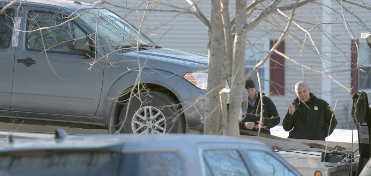 On March 20, Gardiner police Chief James Toman, right, and Sgt. Todd Pilsbury hoist the pickup in which Kenneth Bryant shot himself a day earlier at 16 Fairview St. in Gardiner. Police and fire investigators concluded this week that Bryant shot his estranged wife, Autumn Bryant, in the garage of the residence, drove to Sindey and set her mother's house on fire, then returned to the Gardiner house and killed himself. The pickup was taken to the state police crime laboratory for further examination, police said.