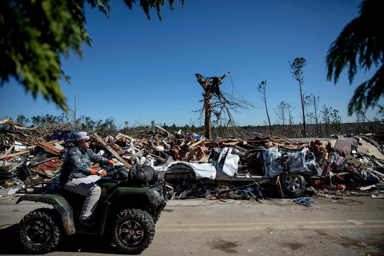 Debris sits on the side of a road in a neighborhood devastated by a tornado in Beauregard, Ala., Tuesday, March 5, 2019. 