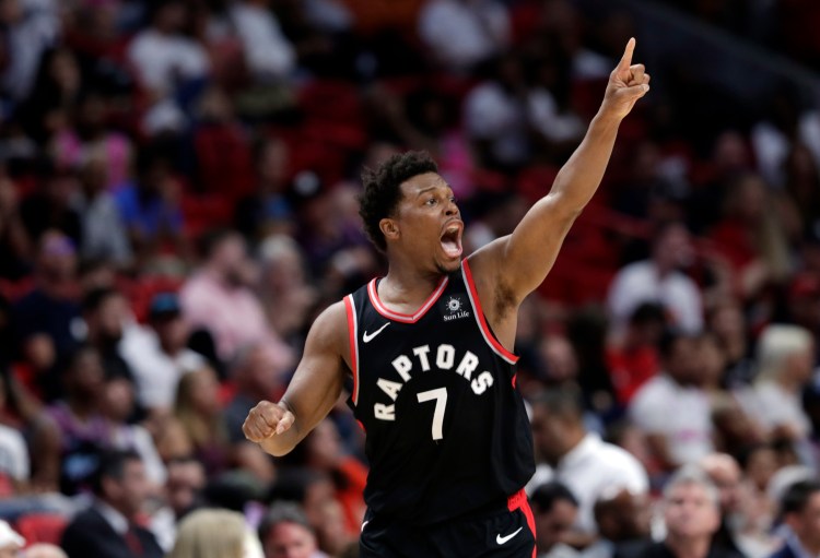 Toronto guard Kyle Lowry reacts after shooting a 3-pointer during the second half of the Raptors' 125-104 win over the Miami Heat on Sunday in Miami.