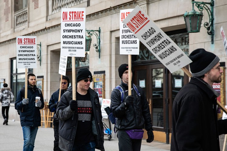 Musicians of the Chicago Symphony Orchestra go on strike and walk the picket line outside the doors of Orchestra Hall on Michigan Avenue on Monday.
