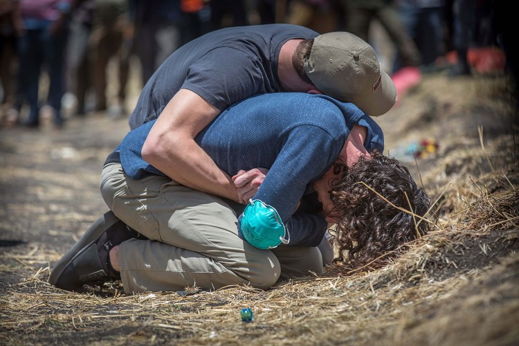 Grieving families gathered at the site where an Ethiopian Airlines Boeing 737 Max 8 crashed shortly after takeoff on Sunday killing all 157 on board, near Bishoftu, south of Addis Ababa, in Ethiopia on Wednesday.  