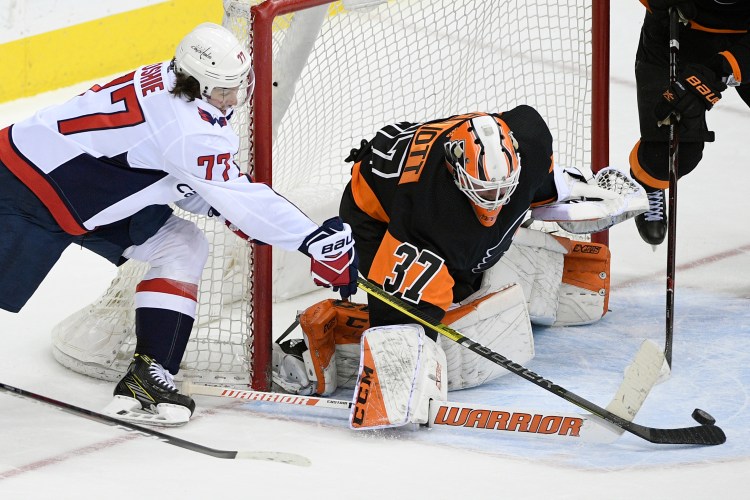 Washington Capitals right wing T.J. Oshie tries to get the puck past Philadelphia Flyers goaltender Brian Elliott during the Capitals' 3-1 win Sunday in Washington.