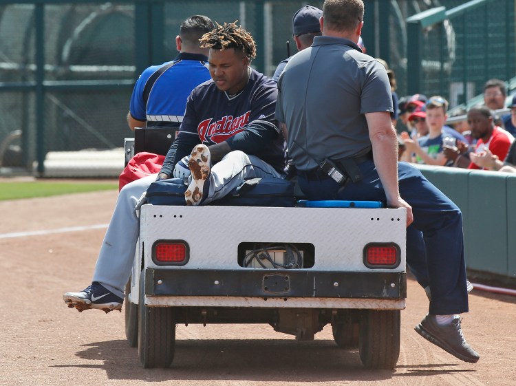Cleveland's Jose Ramirez is taken off the field on a cart after fouling a ball off his leg duruing the Indians' spring training game against Chicago on Sunday in Glendale, Arizona. X-rays were negative but Ramirez's status for Opening Day is uncertain.