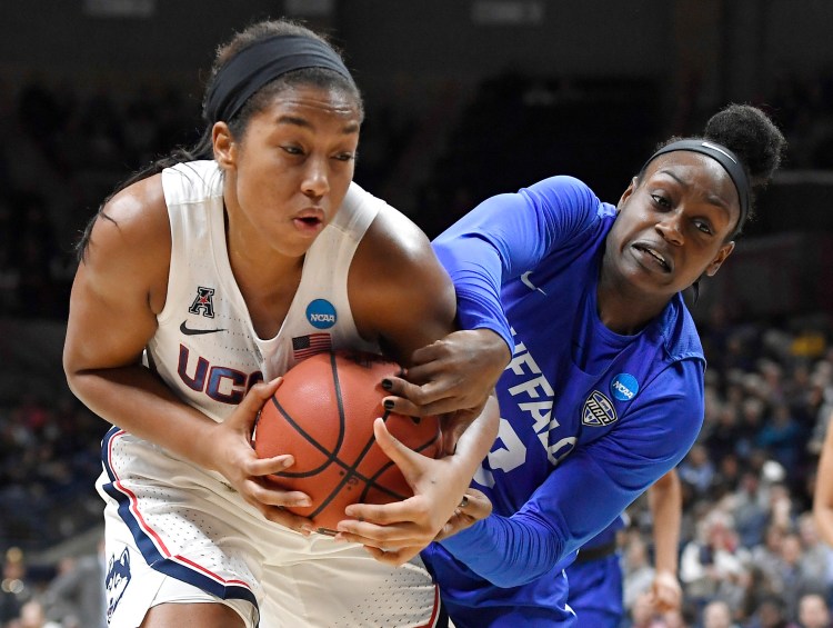 Buffalo's Brittany Morrison, right, pressures UConn's Megan Walker during the Huskies' 84-72 win in the second round of the NCAA tournament on Sunday in Storrs, Connecticut.