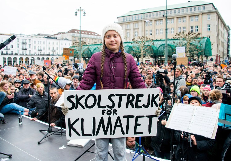 Swedish climate activist Greta Thunberg holds a protest poster as she attends a protest rally in Hamburg, Germany, on March 1. The slogan reads '"School Strike For The Climate." Today's Maine Voices columnists say Thunberg has quickly risen to international hero status on social media for her straight-to-the-point truth-telling to politicians and CEOs about the "unimaginable amounts of money" made by those sacrificing their future.
