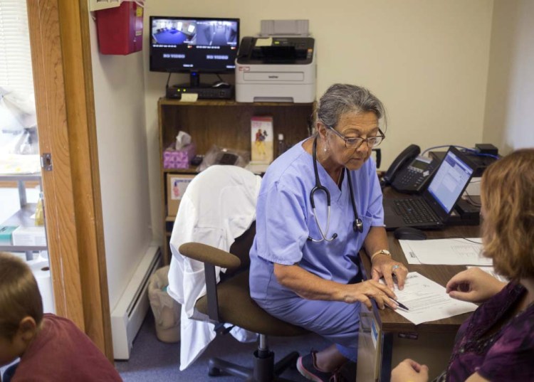 Priscilla Perry, a nurse practitioner with Maine Family Planning in Machias, consults with one of her patients who wished to have her contraception removed in 2017. She applauds efforts to remove barriers to reproductive health services in rural Maine.