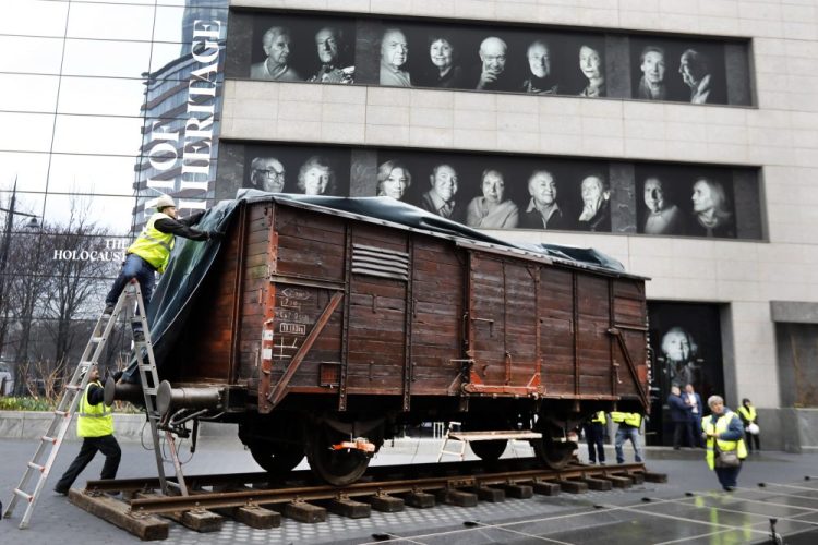 A train car similar to those that were used to transport the Holocaust's victims to concentration camps arrives at the Museum of Jewish Heritage on Sunday.
