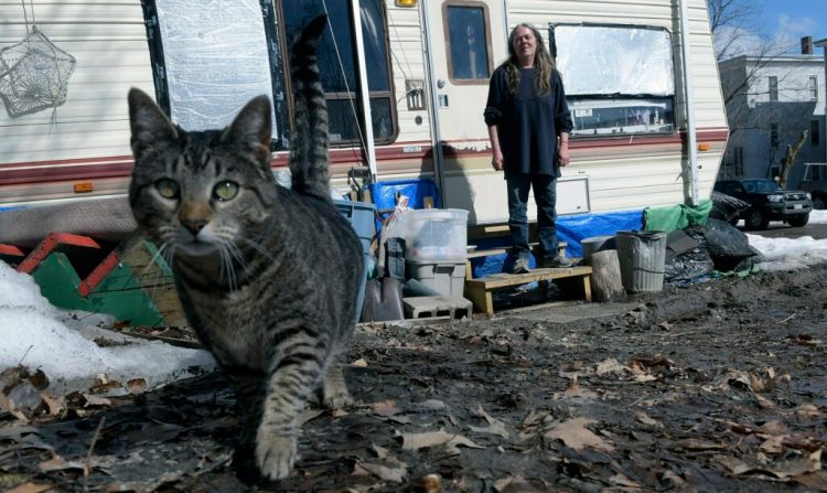 Lana Stafford and her cat outside the camper where she resides in Augusta. The Augusta City Council is scheduled to discuss prohibiting residing in campers year-round in the city.