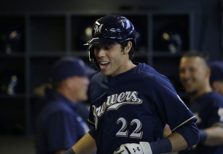 Milwaukee's Christian Yelich celebrates in the dugout after homering in the first inning against the St. Louis Cardinals on Sunday in Milwaukee. Yelich has homered in four straight games to start the season. 