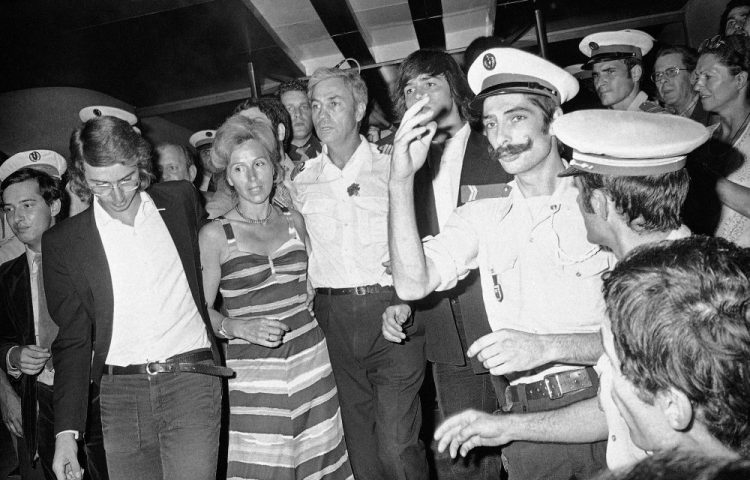 Pilot Michel Bacos, center left, is reunited with his wife, second left, and son at Orly Airport near Parisin 1976. 