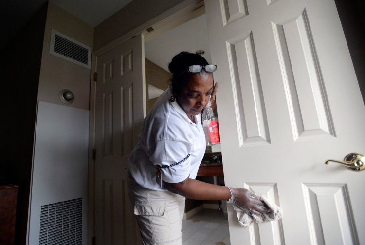 Merlene Warren of Montego Bay, Jamaica, cleans a guest room at the Meadowmere Resort in Ogunquit in 2013. Warren was working temporarily in the U.S. with an H-2B Visa.