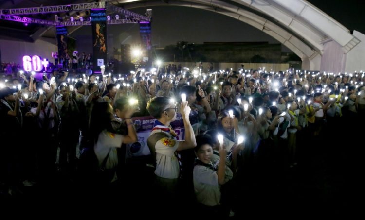 Philippine Boy Scouts switch on their flashlights at the countdown for the 12th Earth Hour event Saturday in Manila, Philippines. Earth Hour is the symbolic switching off of the lights for one hour to help minimize fossil fuel consumption as well as mitigate the effects of climate change.