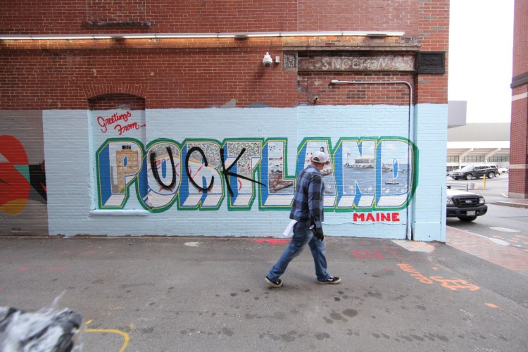 Artist Mike Rich surveys the mural he made for "Puckland." 