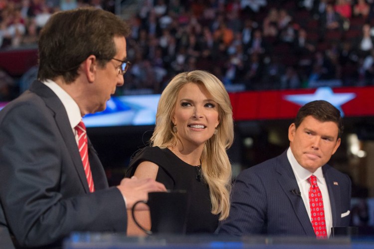Fox News moderators Megyn Kelly, center, and Bret Baier, right, listens as Chris Wallace, left, beings introductions during the first Republican presidential debate in Cleveland in 2015. The Democratic National Committee has decided to exclude Fox News from televising any of its candidate debates during the 2019-2020 cycle as a result of published revelations detailing the cable network’s close ties to the Trump administration.