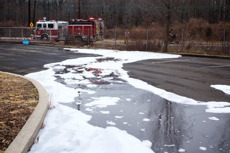 Firefighting foam remains on the ground after a tanker truck accident in Bensalem, Pa., on Feb. 7. The governor's task force will work to determine how much PFAS-containing firefighting foam is around Maine and identify potential alternatives.