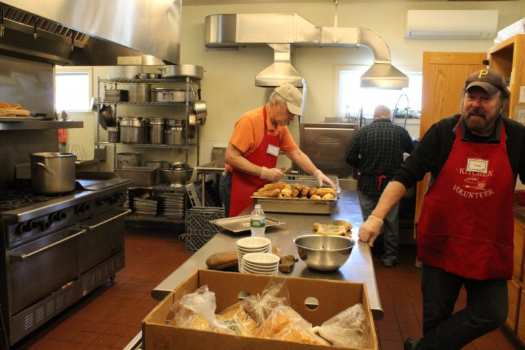 Volunteers at the Midcoast Hunger Prevention Program soup kitchen prepare lunch on Wednesday. The kitchen has experienced a 50,000 meal-per-year increase over the last two years, and in January and February, the food bank experienced its busiest two months ever. 