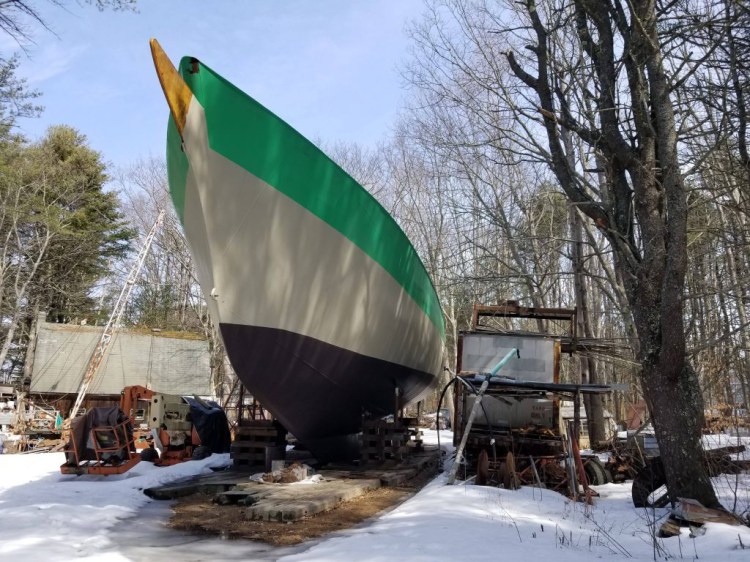 The Island Rover, a 113-foot-long vessel built of recycled steel, sits on a private right of way in Freeport, ready to hit the water but with no immediate way to do so.  Hannah LaClaire/The Times Record
