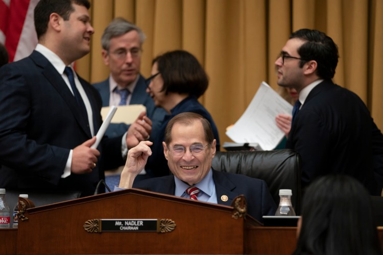 House Judiciary Committee Chair Jerrold Nadler, D-N.Y., surrounded by his staff, passed a resolution to subpoena special counsel Robert Mueller's full report Wednesday.