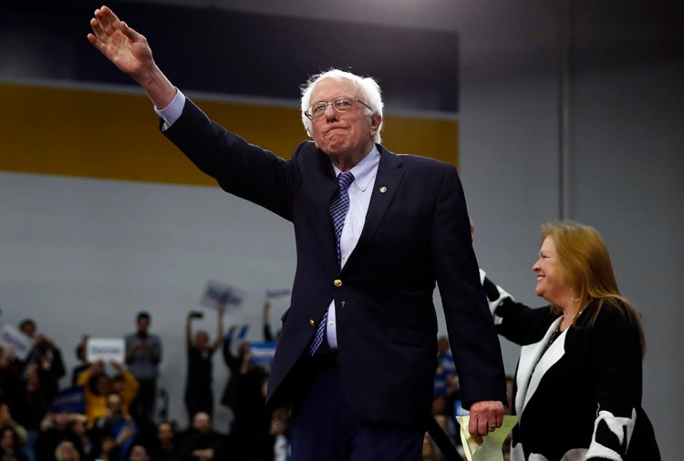 Democratic presidential candidate Sen. Bernie Sanders, accompanied by his wife, Jane O’Meara Sanders, arrives to speak to supporters Tuesday at his primary night election rally in Manchester, N.H., Tuesday. Sanders was the winner of the primary.