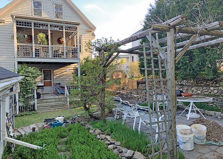 Gregory Adams’s backyard in Portland’s Oakdale neighborhood is full of DIY projects, from his pergola covered patio to the terraced gardens. His composting system, rear center, is seamlessly integrated into the landscaping.