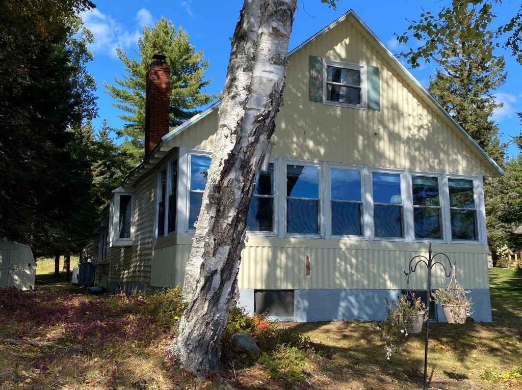 Set on 100 feet ± of Rangeley Lake, this year-round home has three bedrooms, one bathroom and a two-car garage, a somewhat rare find in this area.