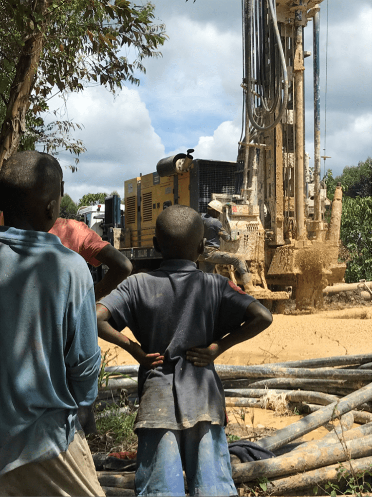 Community observing the drilling of a water supply well in the Lwengo District, Nakenyi, Uganda.