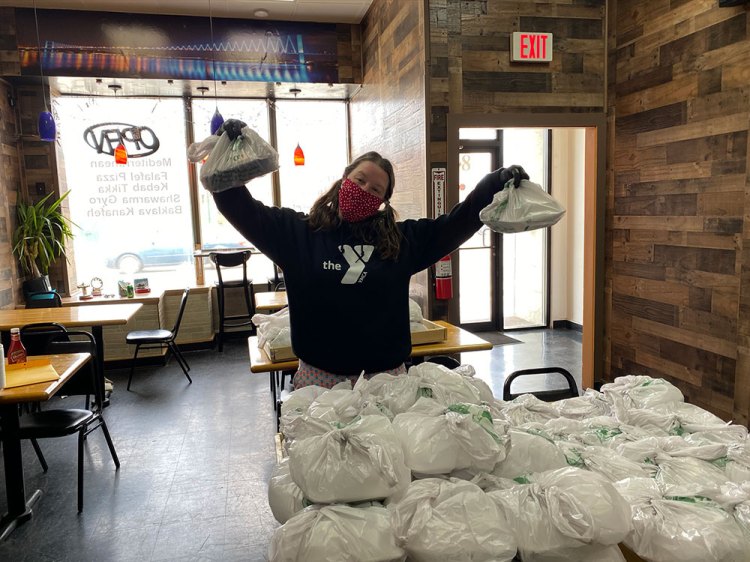 A YMCA volunteer picks up halal meals from Istanbul Restaurant to deliver to meal recipients during Ramadan 2020. The restaurant was compensated for food and labor costs by Cooking for Community.