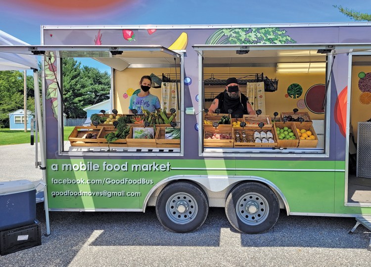 Good Food Bus market leaders Sophia Garmache and Jay Fiori are ready to help customers pick out their purchases during a market day this past summer.